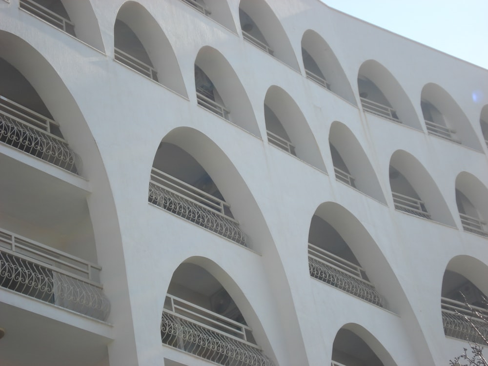 a white building with many balconies and balconies