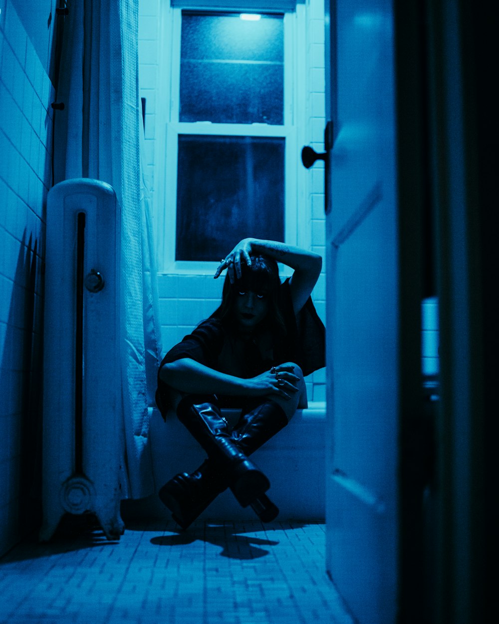 a person sitting on a toilet in a bathroom