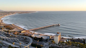 an aerial view of a beach and a pier