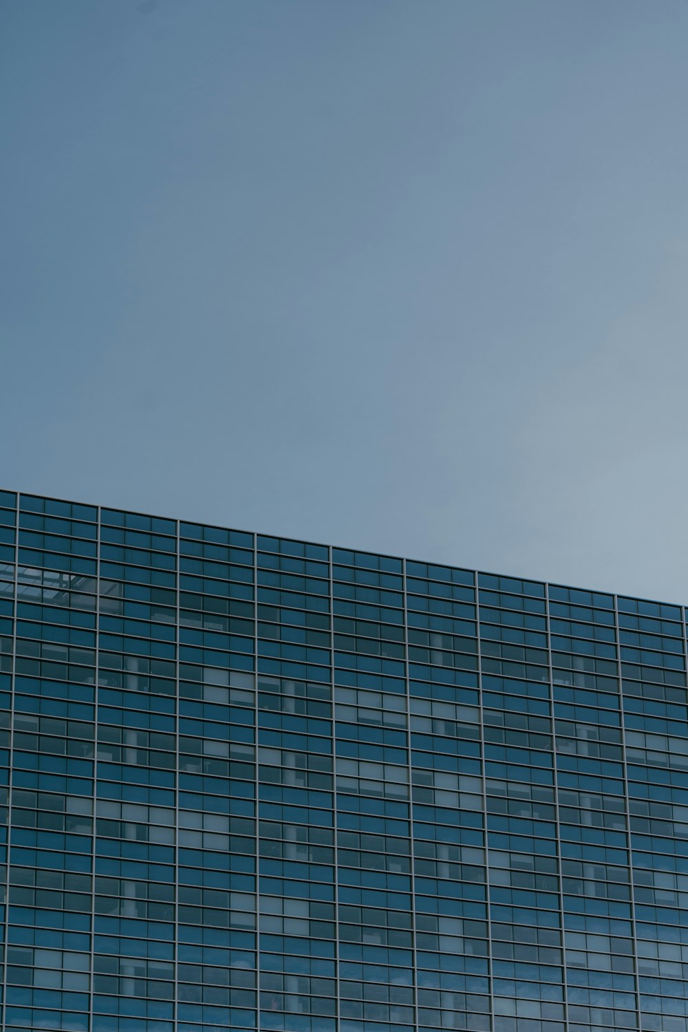 a plane flying in the sky over a building