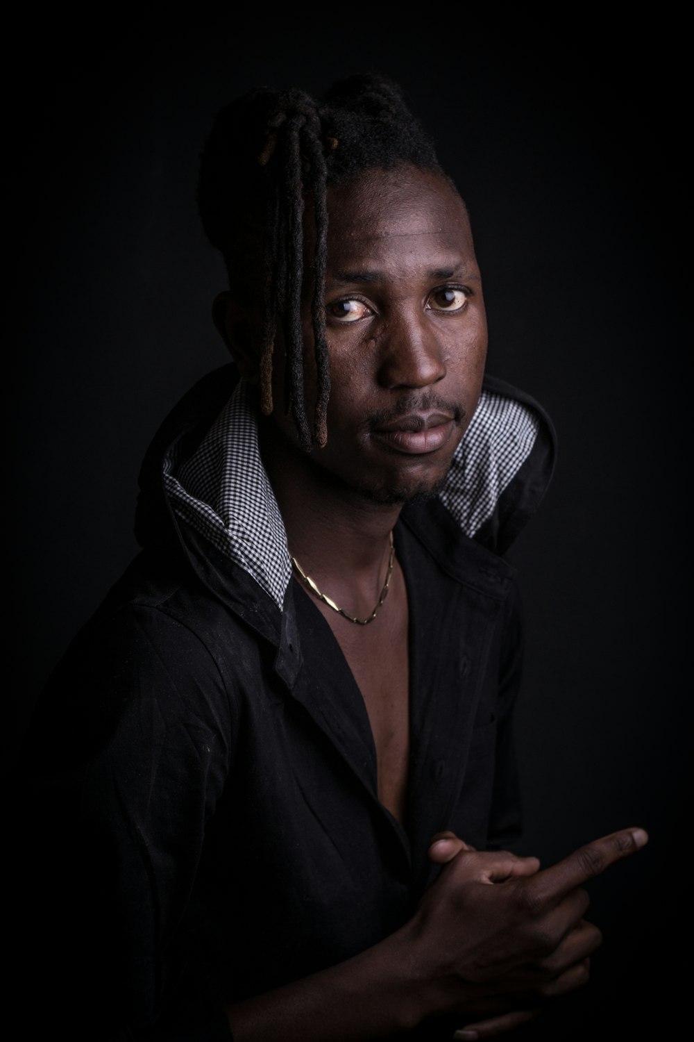 a man with dreadlocks is posing for a picture