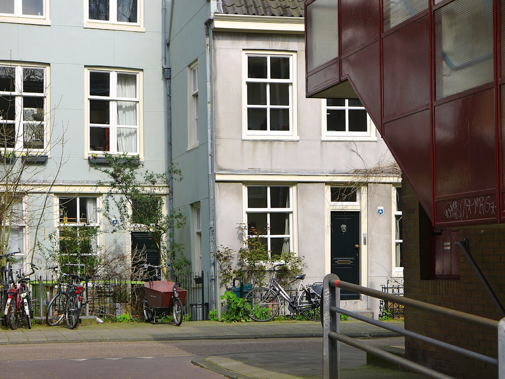 a couple of bikes parked in front of a building