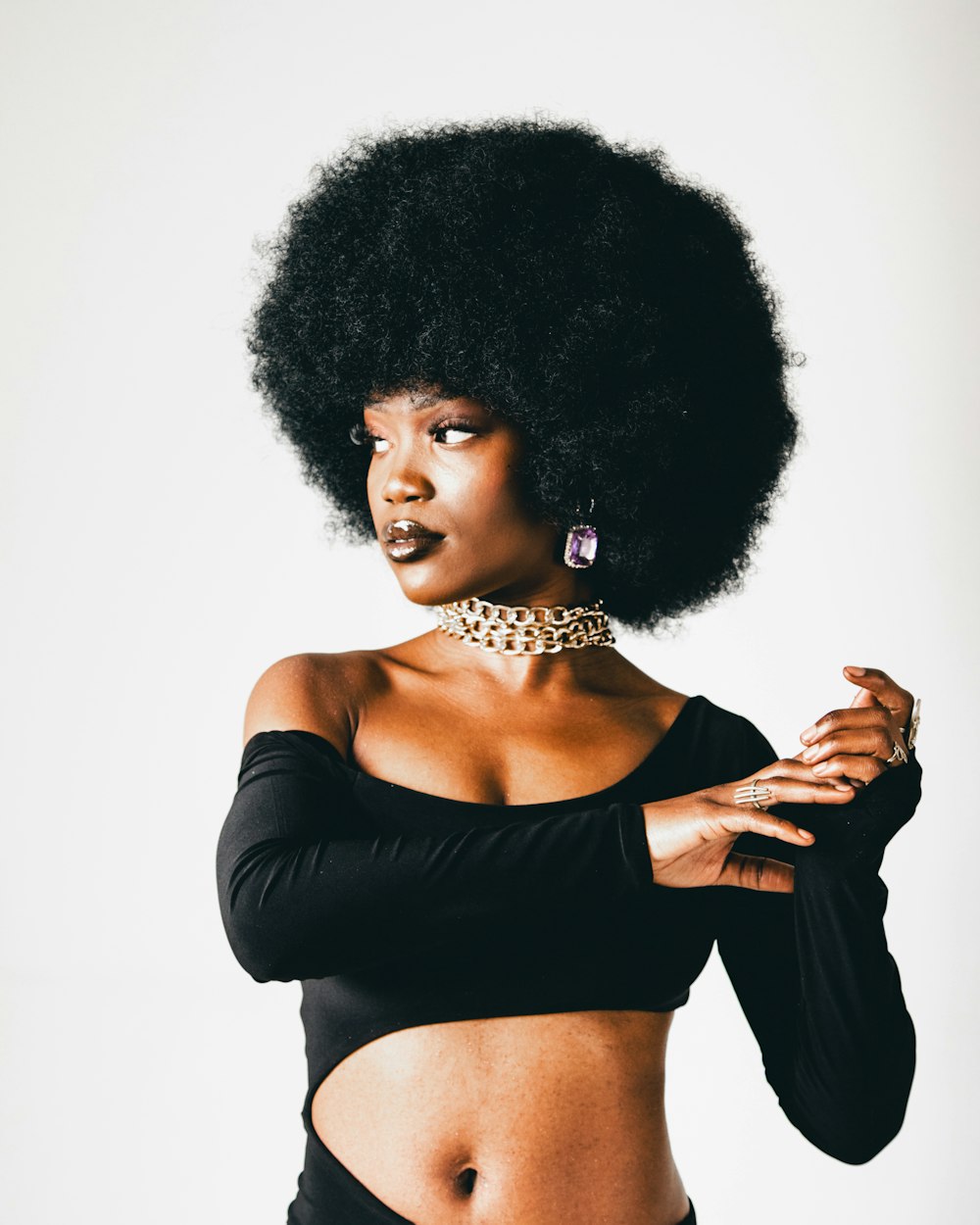 a woman with an afro is posing for a picture