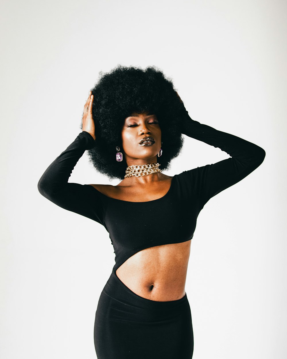 a woman with an afro is posing for a picture