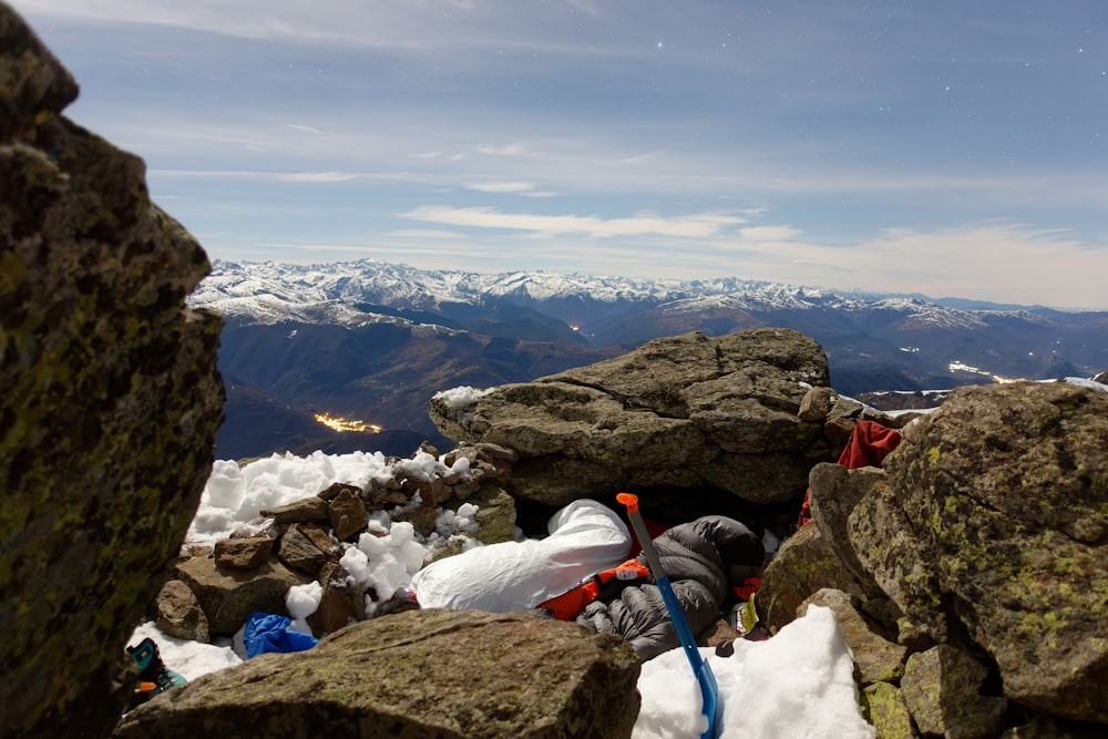 a backpack sitting on top of a mountain covered in snow