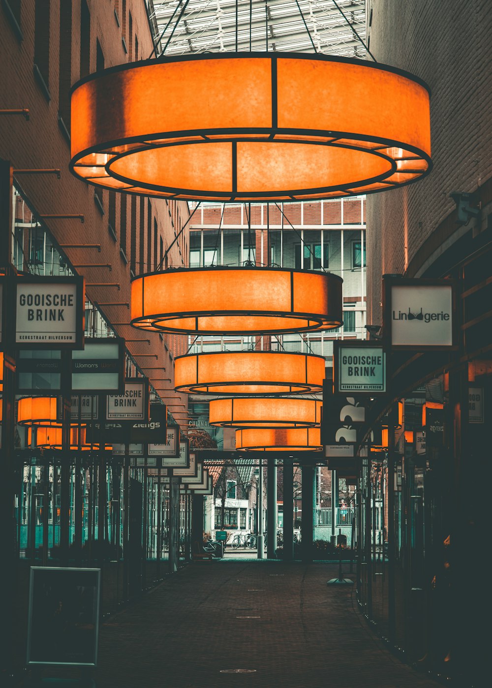 a large orange light hanging from the side of a building