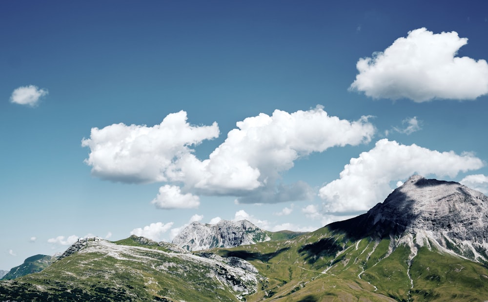 a view of a mountain range with clouds in the sky