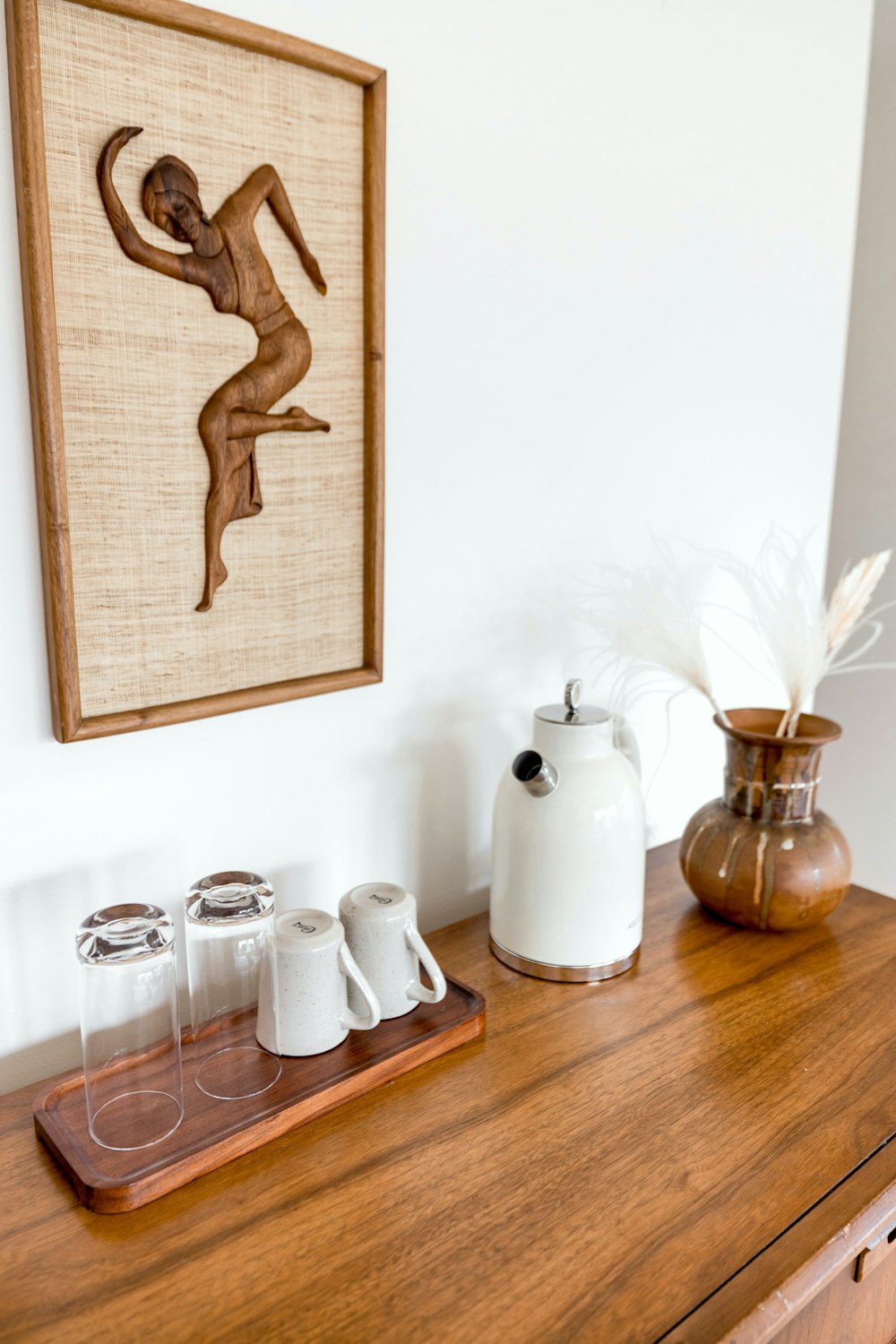 a picture of a woman on a wall above a dresser