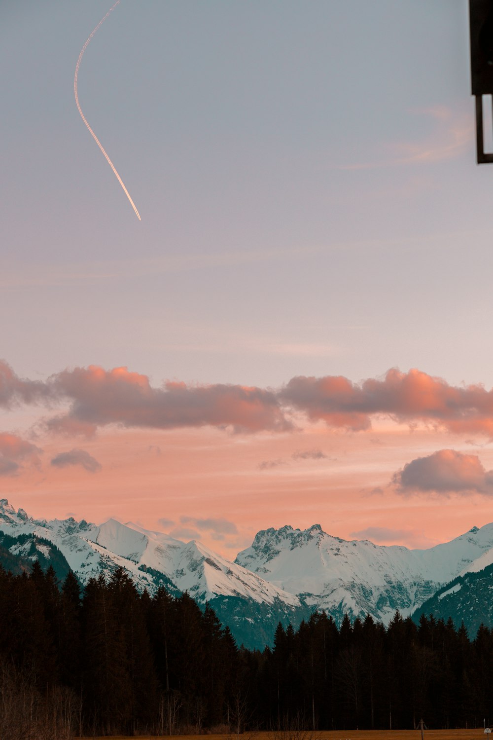 a plane is flying over a mountain range