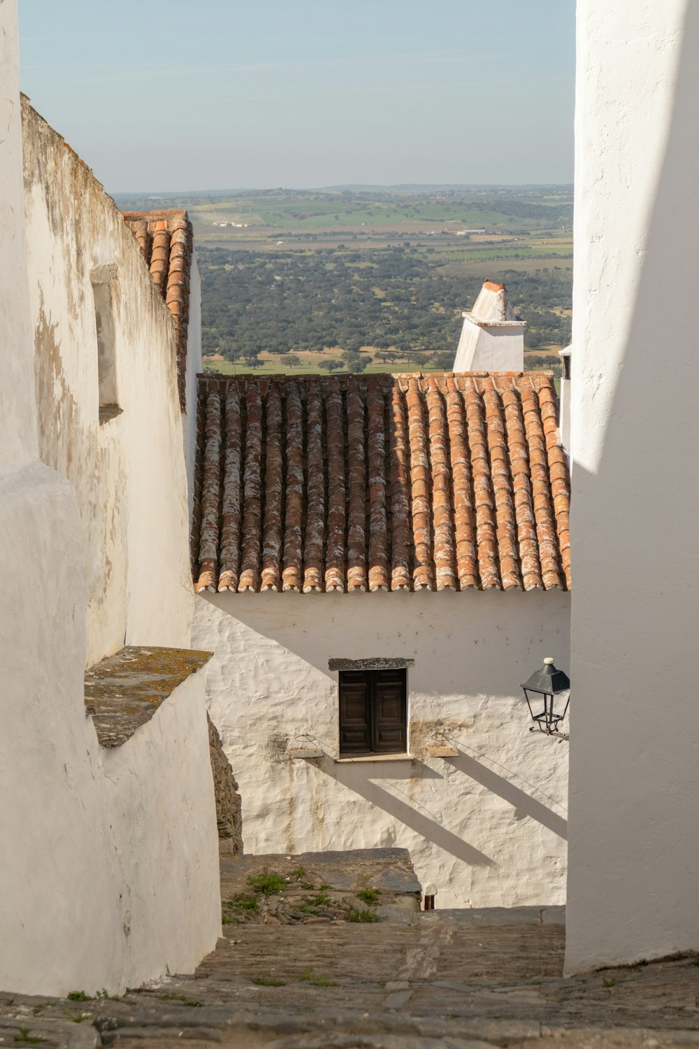 a white building with a red tiled roof