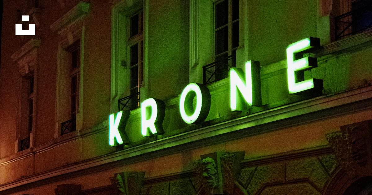 A building with a neon sign that reads krone photo – Free Goldene krone ...