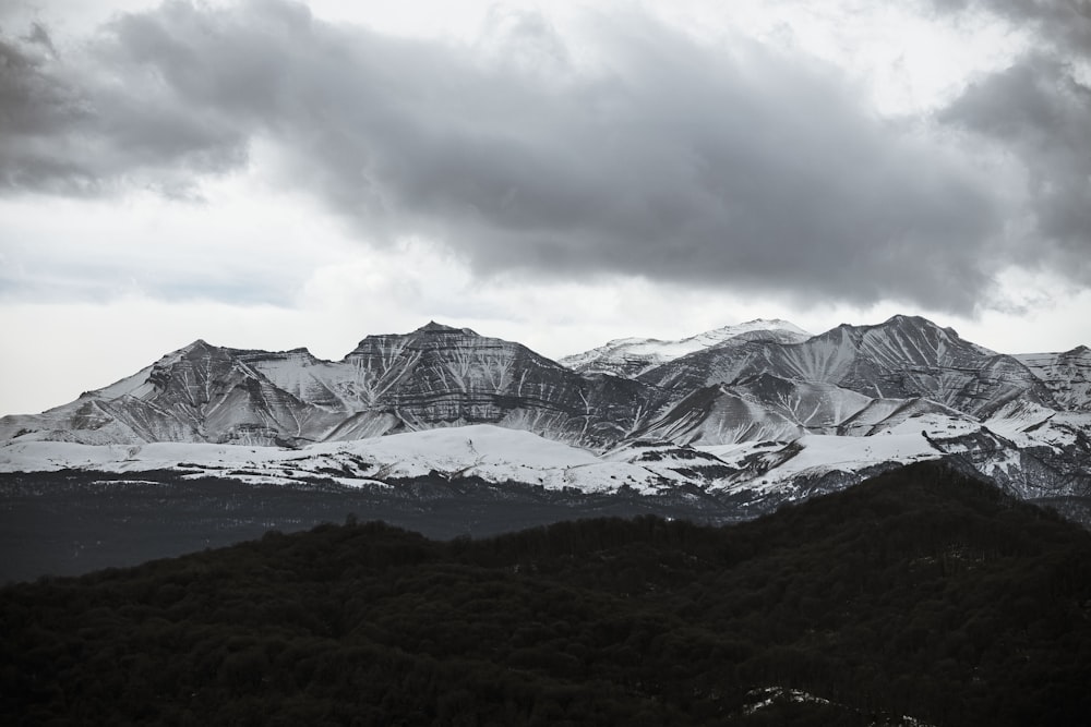 a mountain range with snow covered mountains in the background