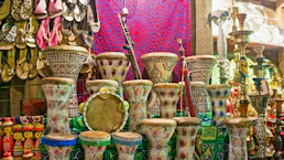 many different colored vases are on display in a store