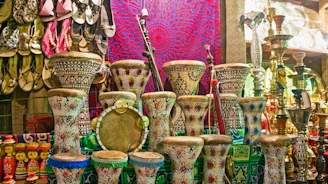 many different colored vases are on display in a store
