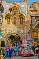 a group of people walking down a street next to a building