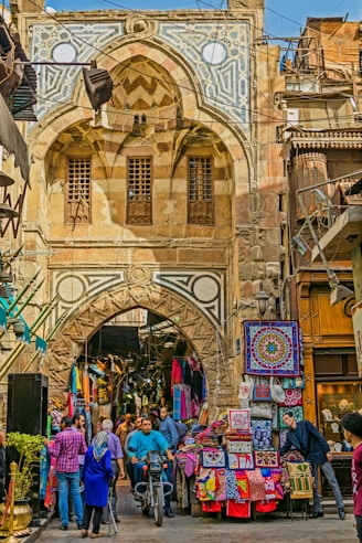 a group of people walking down a street next to a building