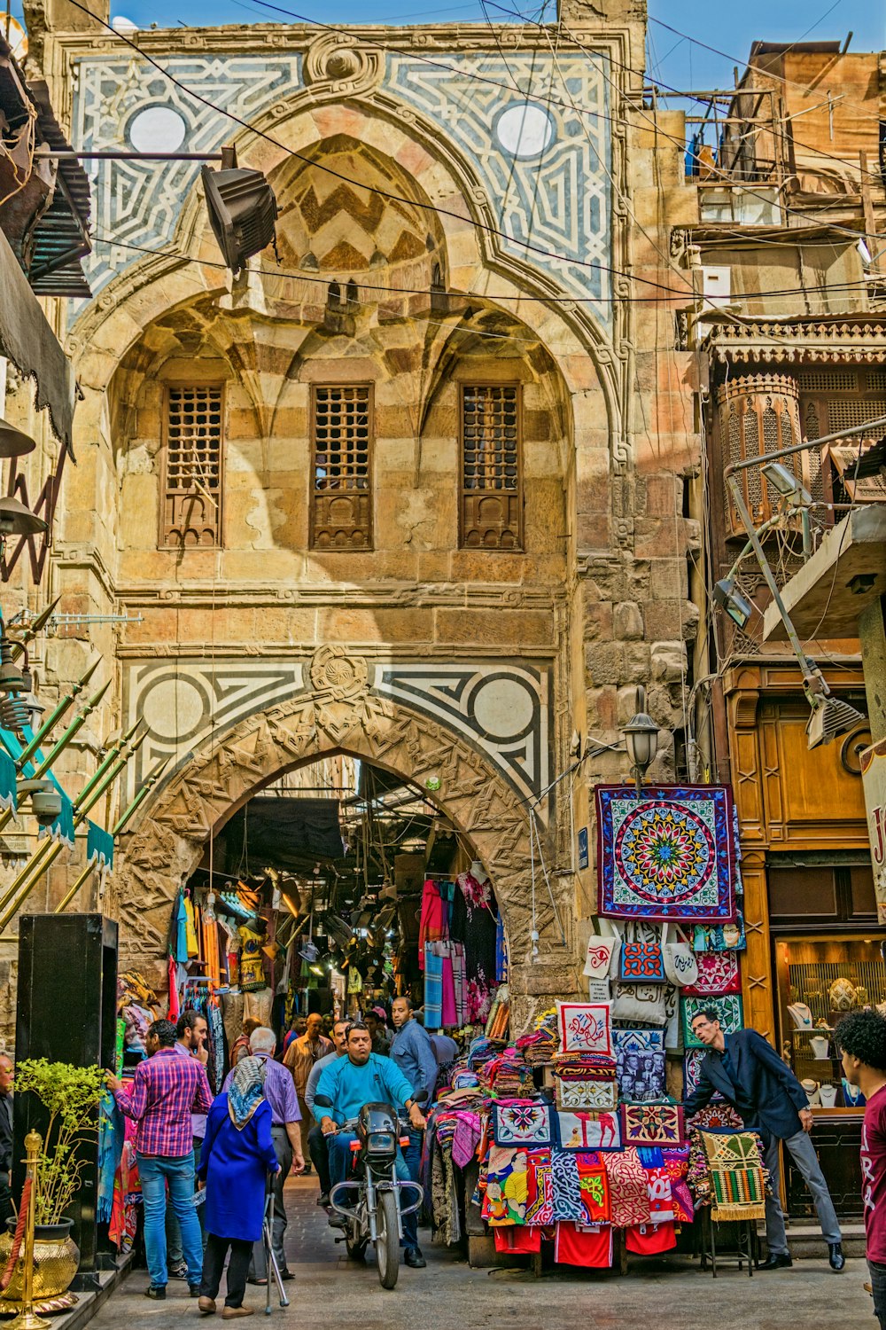 a group of people walking down a street next to a building