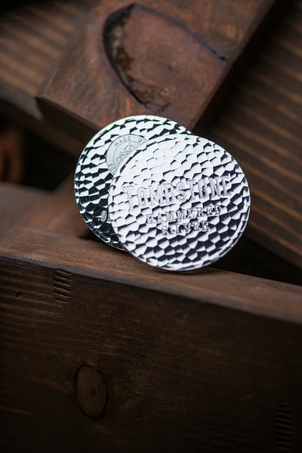 a close up of a metal object on a wooden surface