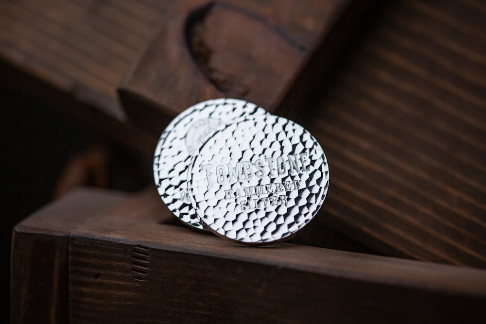 a close up of a metal object on a wooden surface