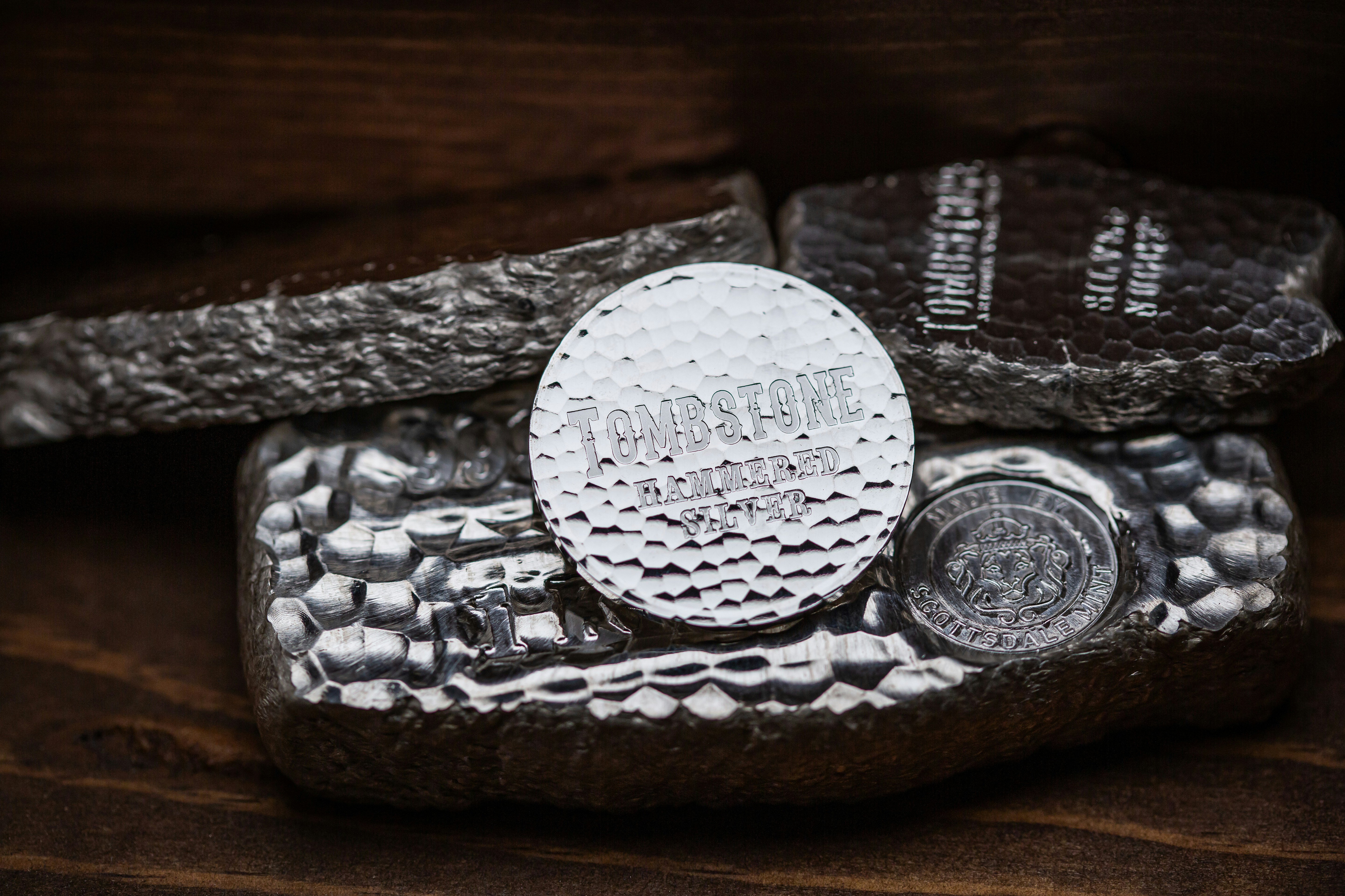 Tombstone Silver Round made by Scottsdale Mint sitting on a wooden antique box.
