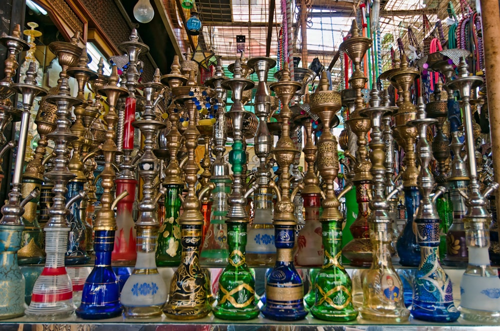 a collection of different colored glass bottles on display