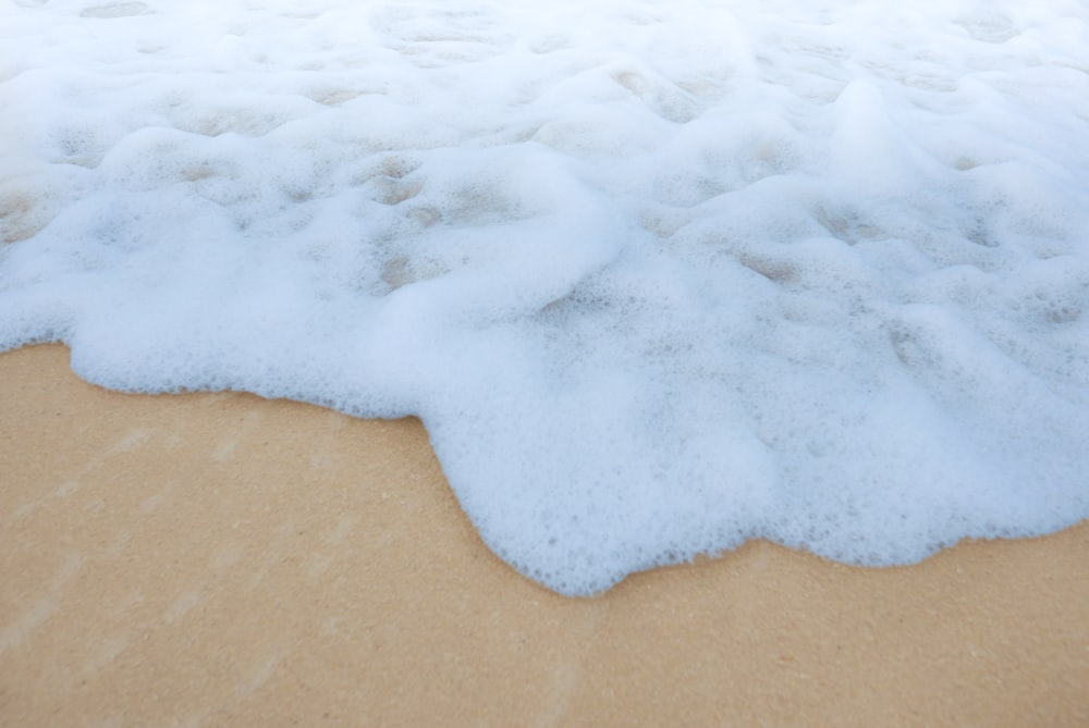 foamy water on the sand of a beach