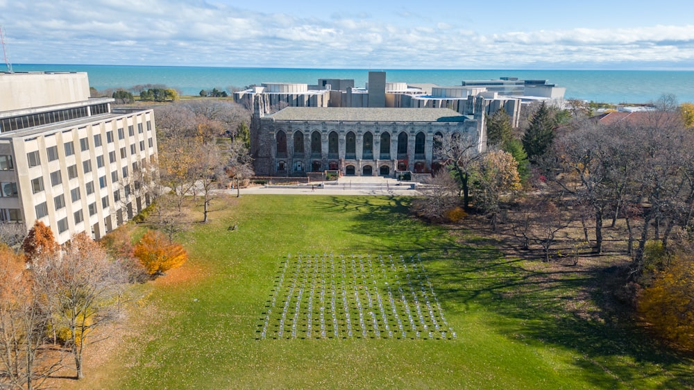 an aerial view of a building with a lawn in front of it