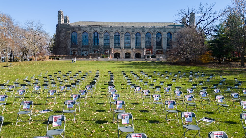 rows of lawn chairs in front of a building