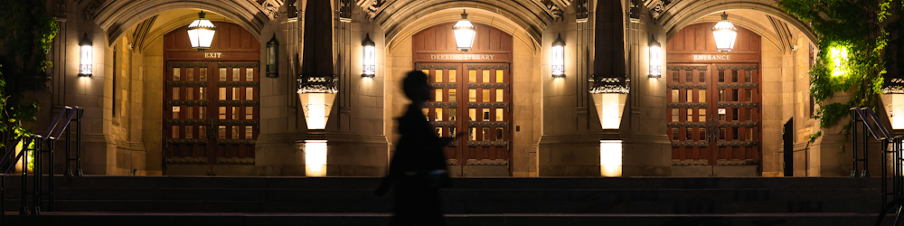 a person standing in front of a building at night