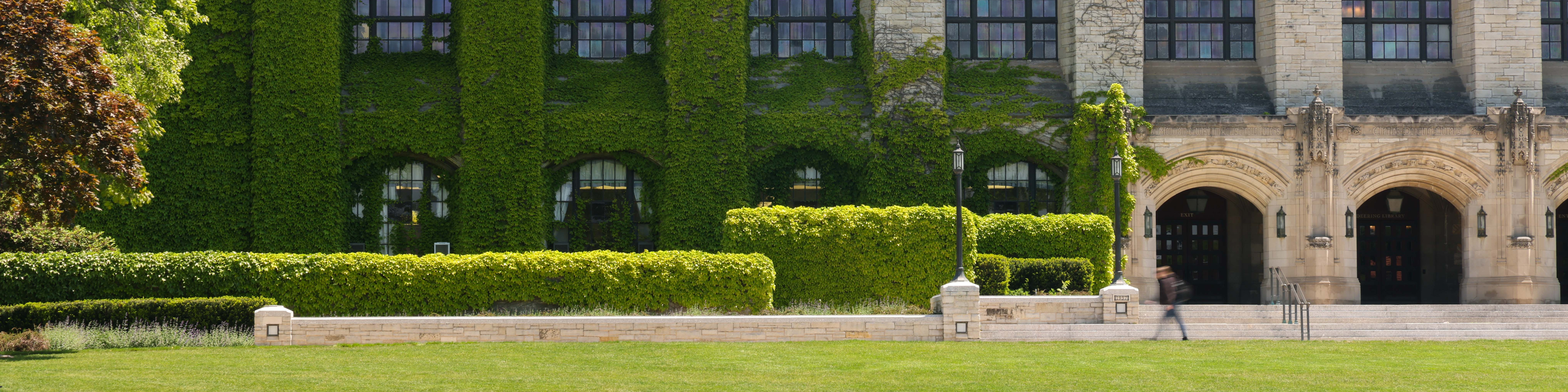 a large building with a lawn in front of it