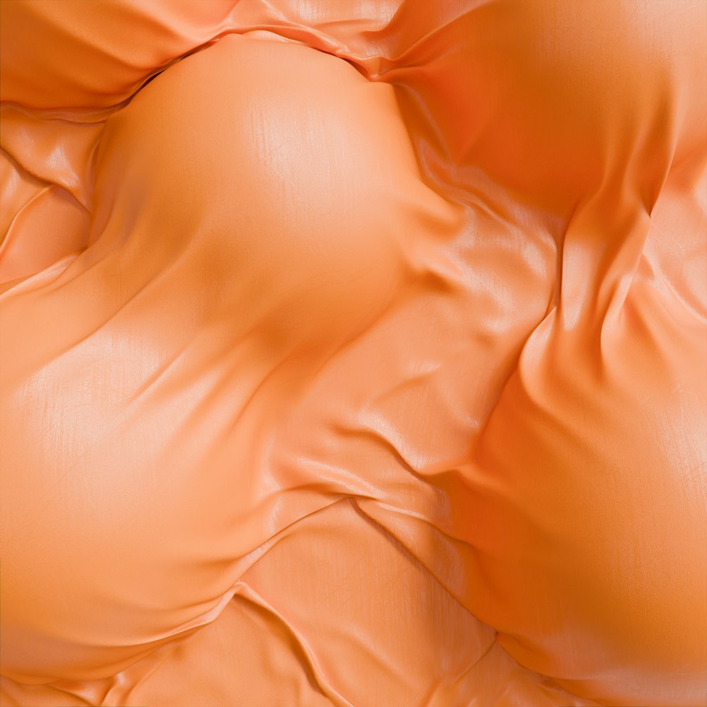 a close up of a bed with orange sheets