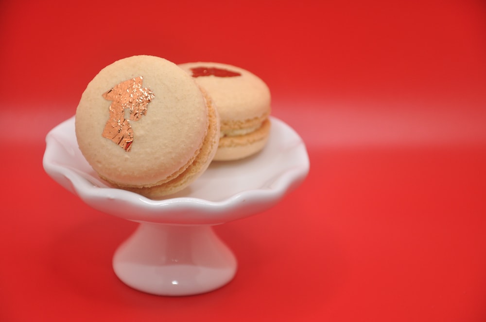 a white plate topped with cookies on top of a red table