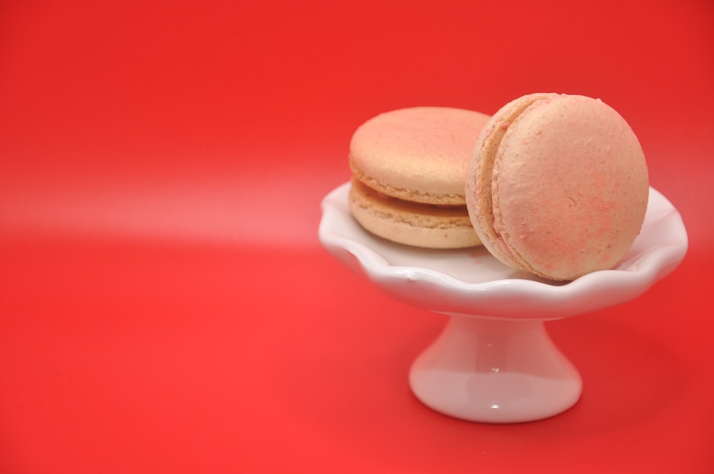 two macaroons sitting on top of a white plate