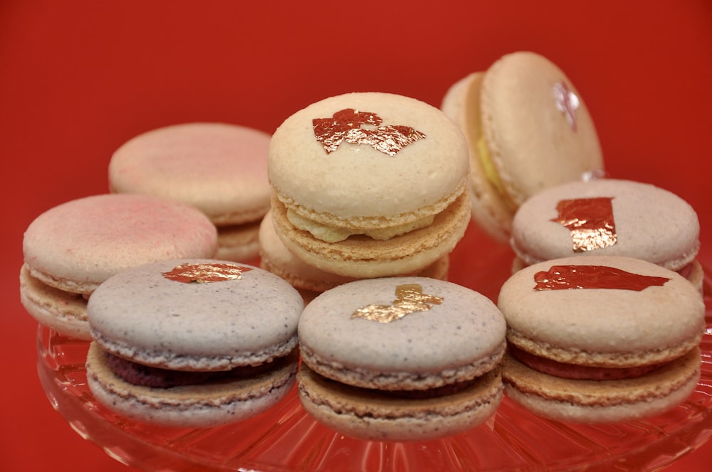 a glass plate topped with macaroons covered in frosting