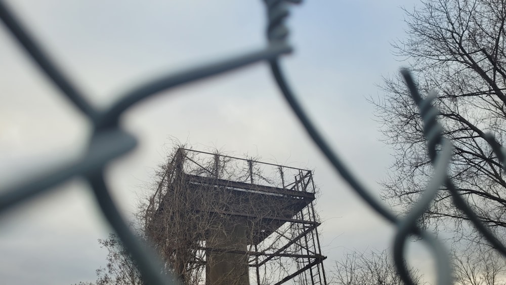 a tall tower sitting behind a metal fence