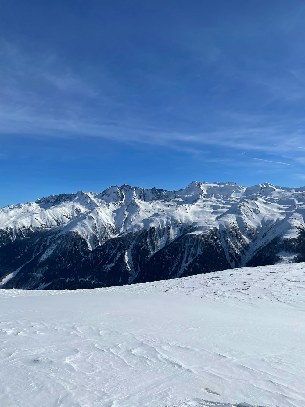 a person standing on top of a snow covered slope