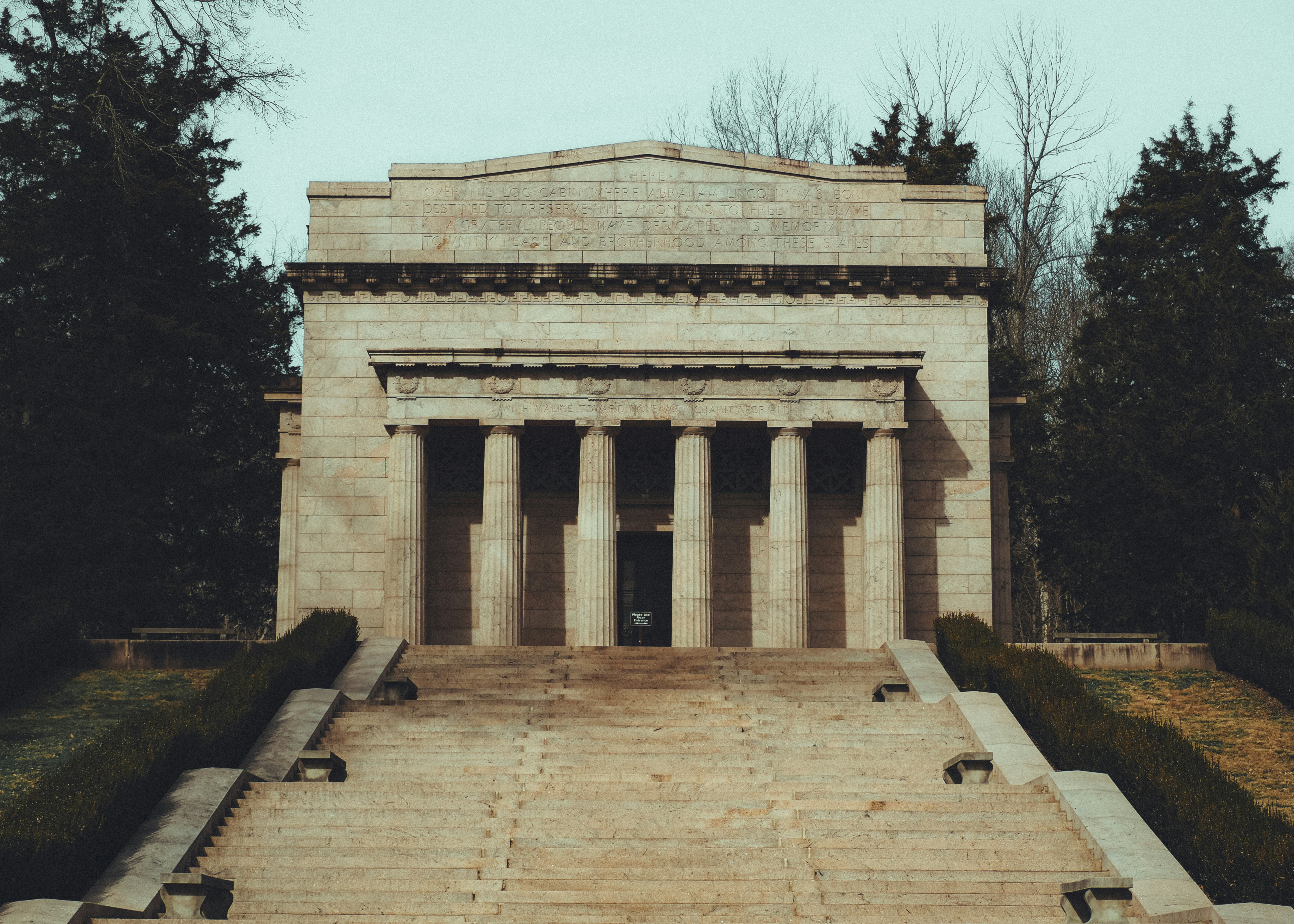 a stone building with columns and steps leading up to it (Photo by Barbara Burgess on Unsplash)