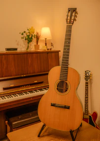 a guitar sitting on top of a table next to a piano