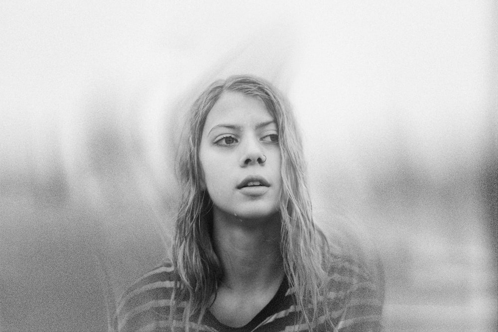 a black and white photo of a woman with long hair