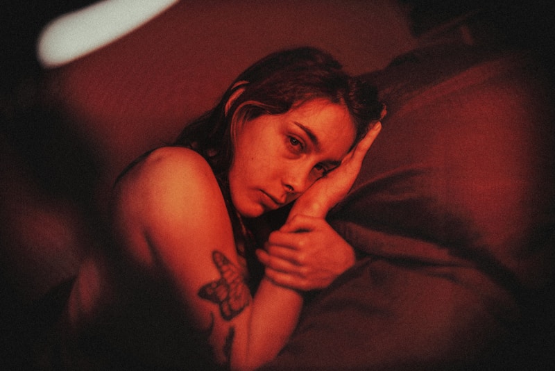 Tattooed woman in bed