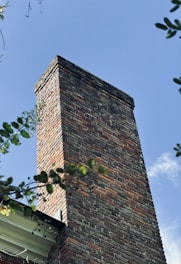 a tall brick chimney on top of a building