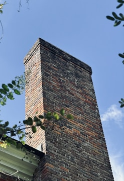 a tall brick chimney on top of a building