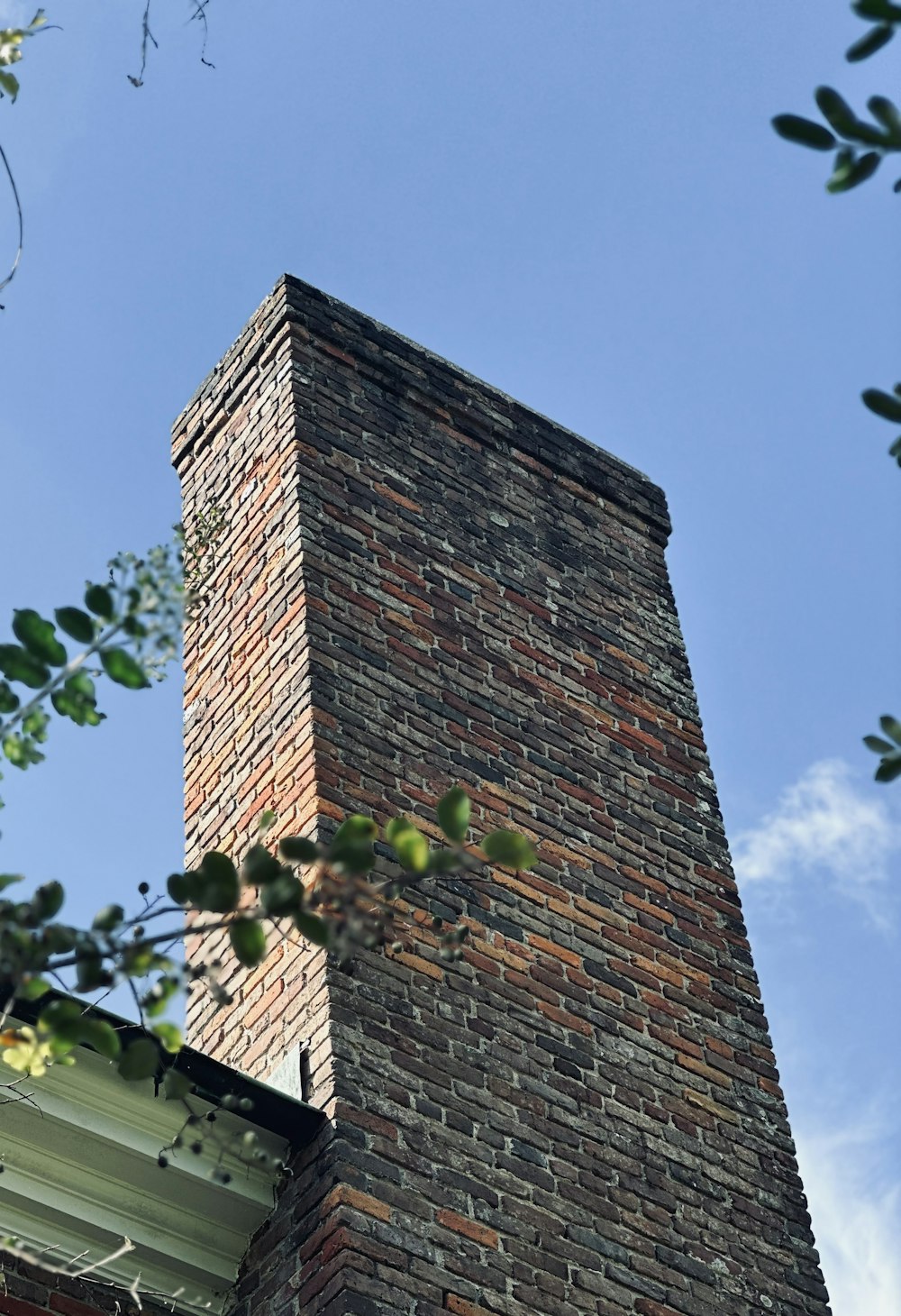 a tall brick chimney on top of a building