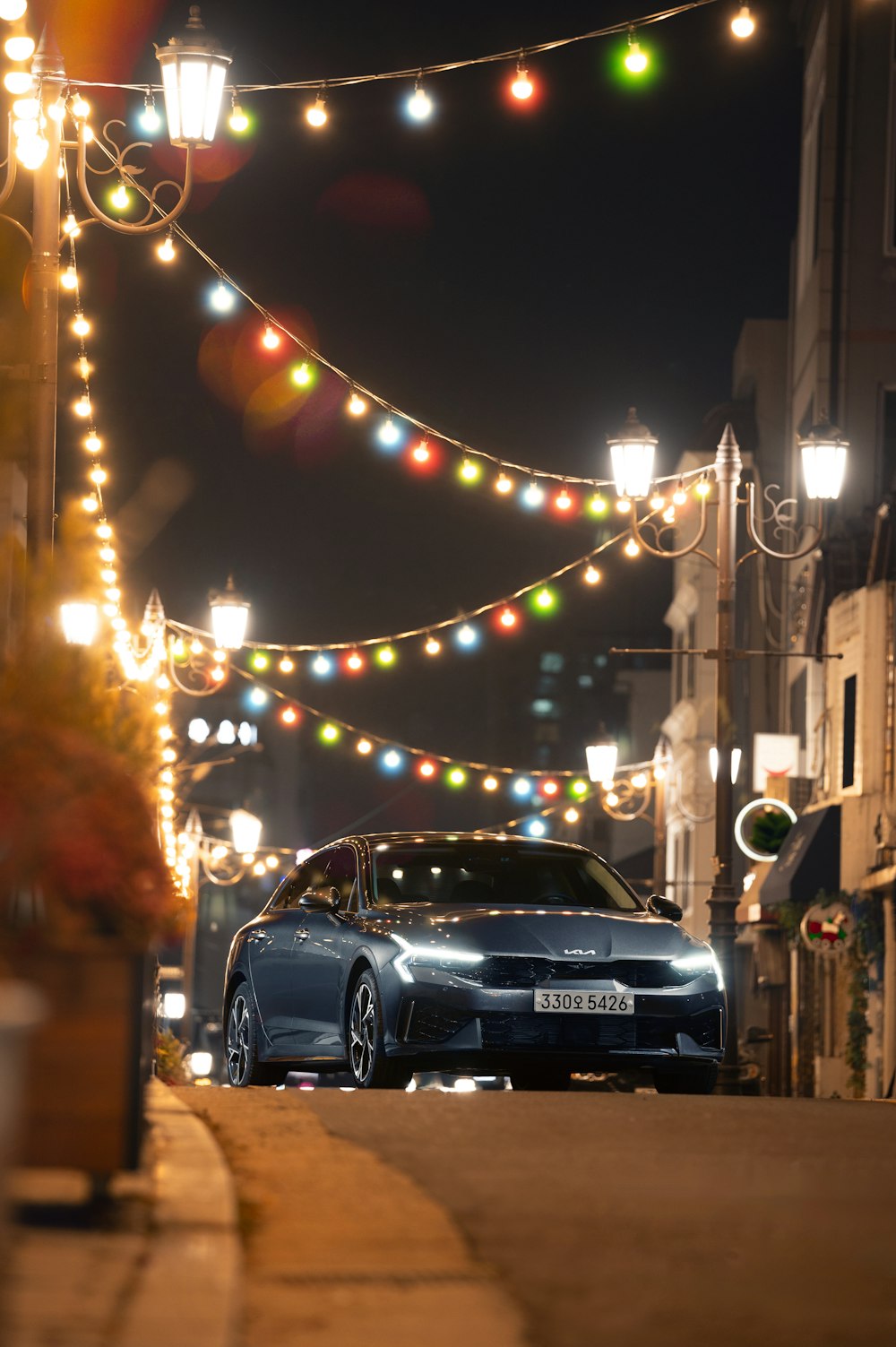 a car parked on the side of a street at night