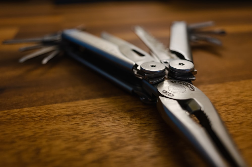 a pair of scissors sitting on top of a wooden table