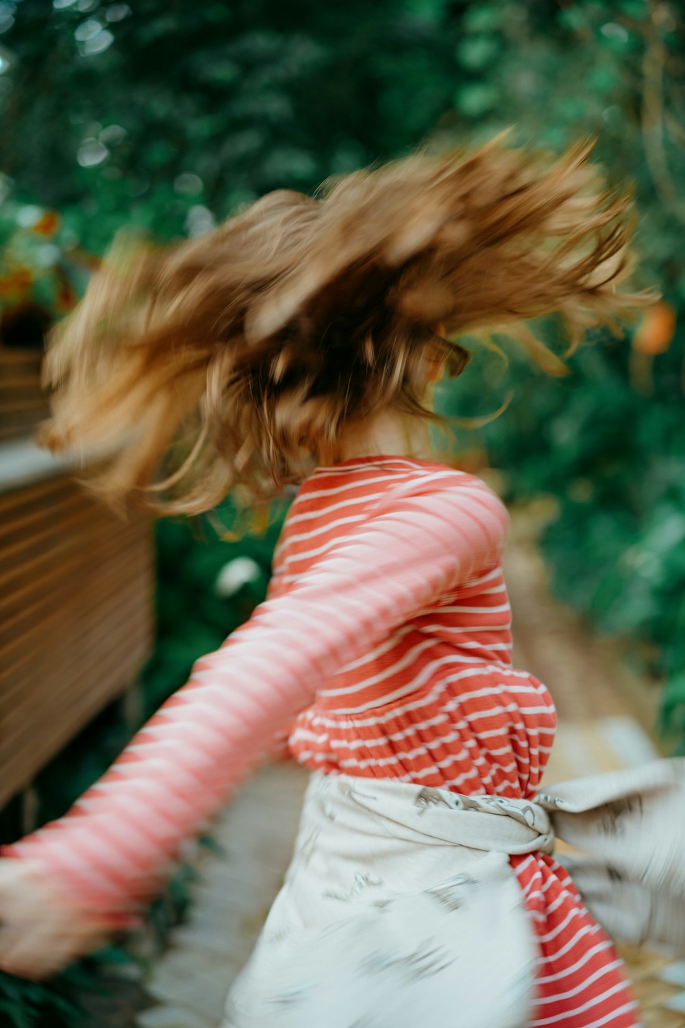 a girl in a red and white striped shirt and white skirt