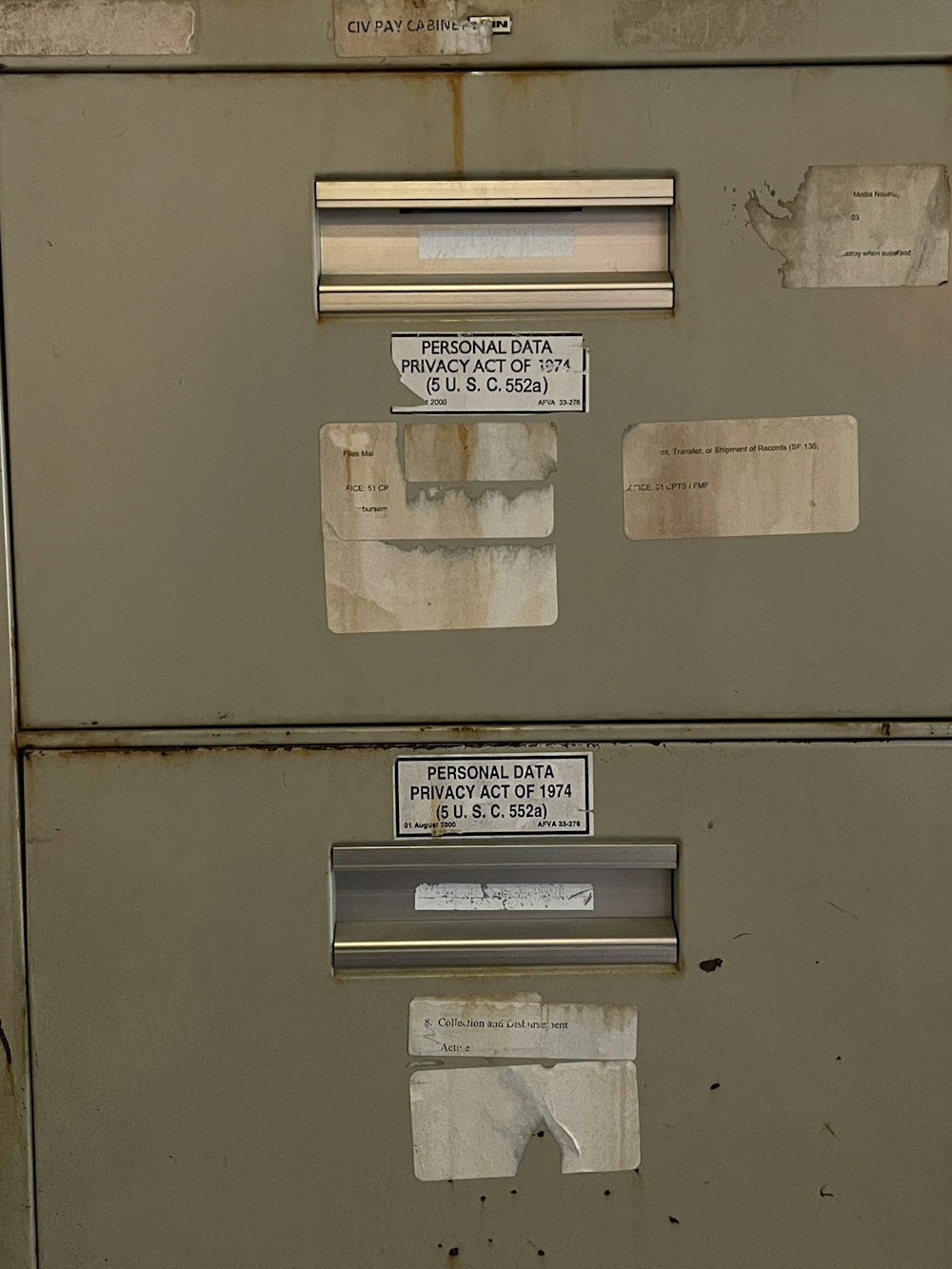 a metal filing cabinet with some stickers on it