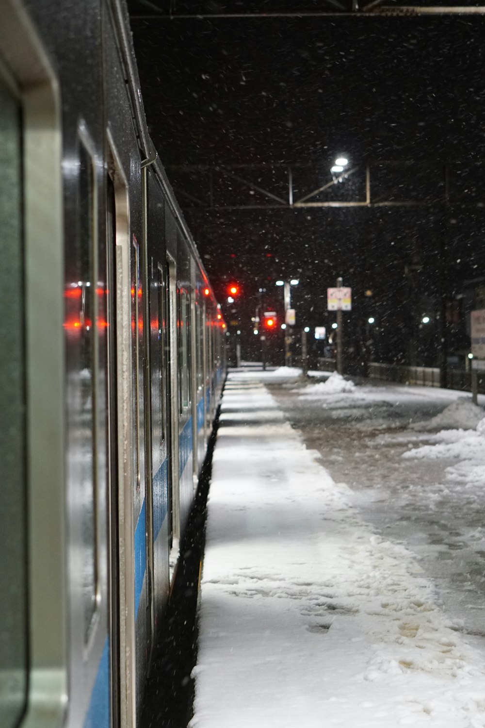 a train traveling down train tracks covered in snow