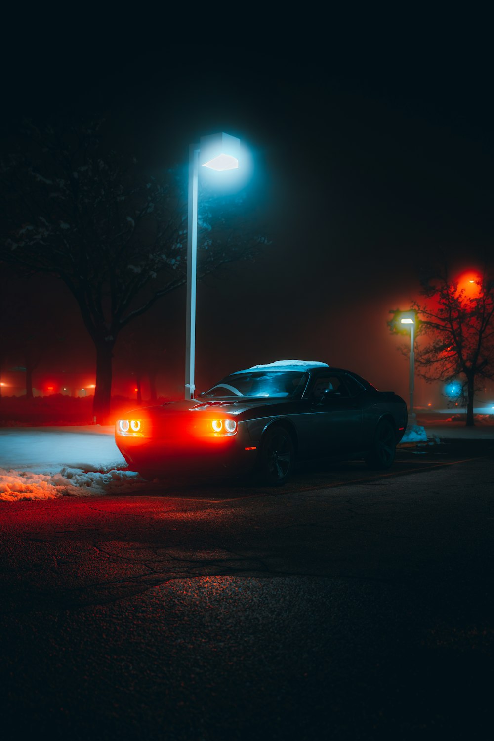 a car parked in a parking lot at night