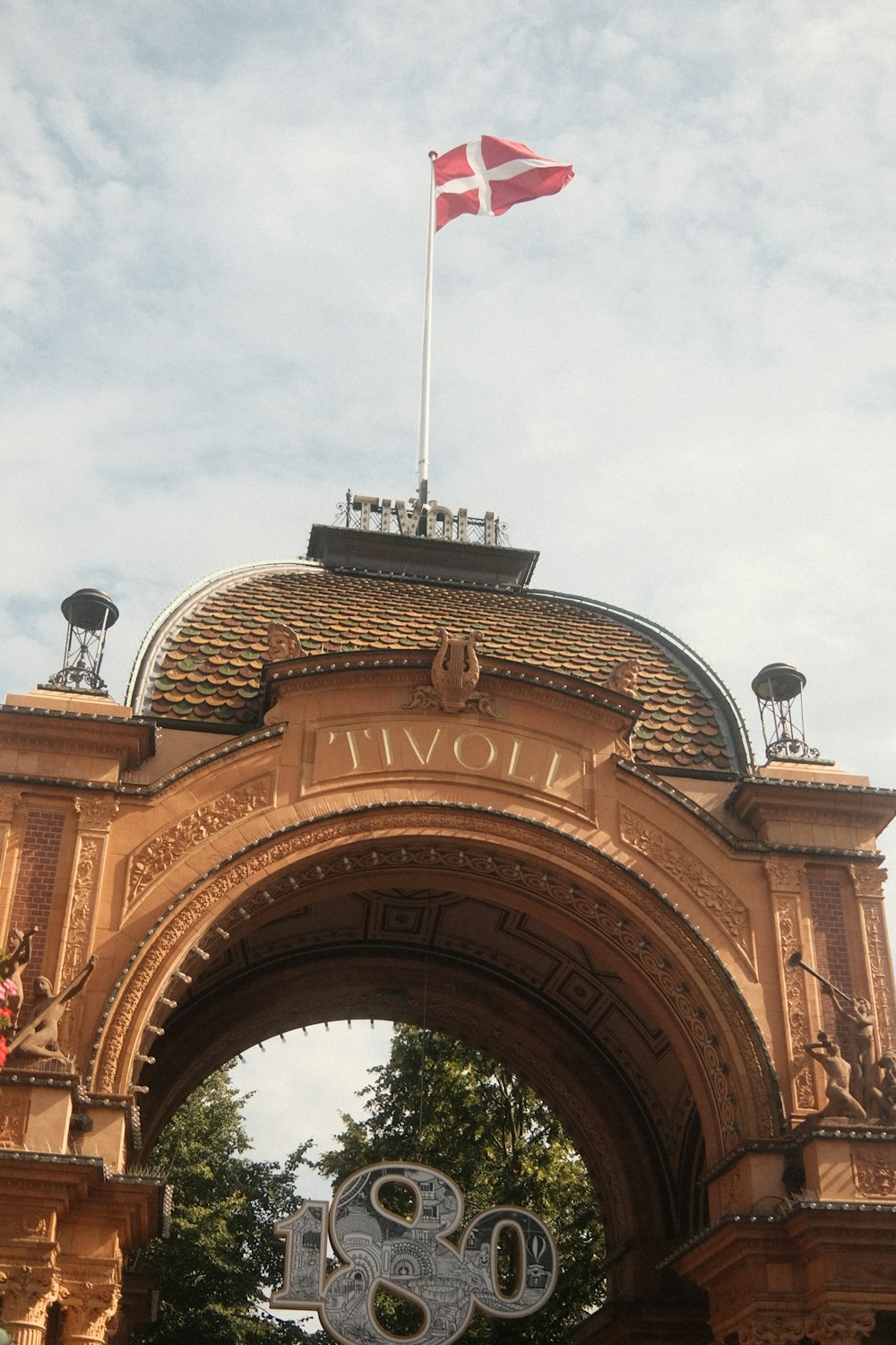 a large arch with a flag on top of it